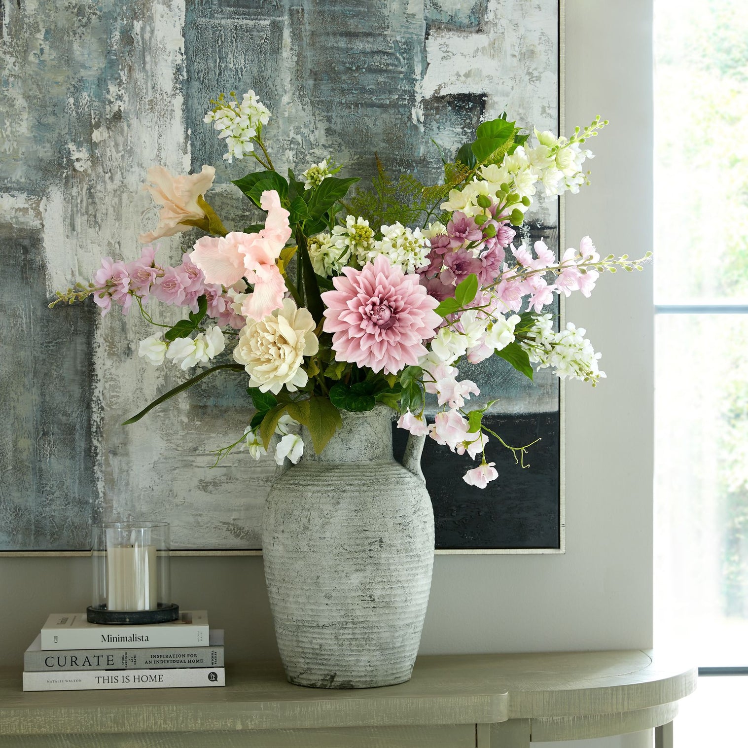 A large bouquet of flowers in a stone vase.