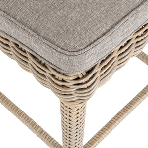 Wicker stool with a gray cushion on a white background