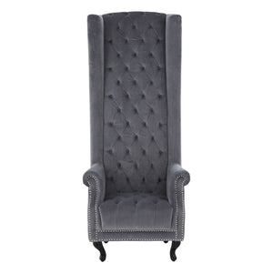 Gray tufted chair with high back and armrests on a white background