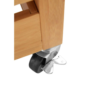 Close-up of a lockable castor on the bamboo leg of the Homestead Kitchen Trolley.