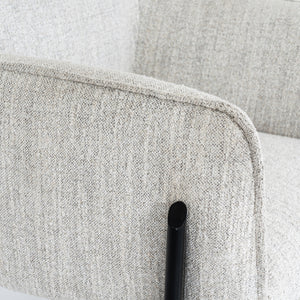Close-up of a textured gray fabric chair with a black frame.