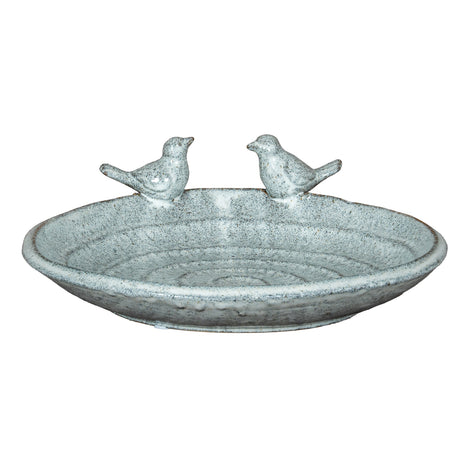 Decorative stone bird bath with two small bird figurines on a white background
