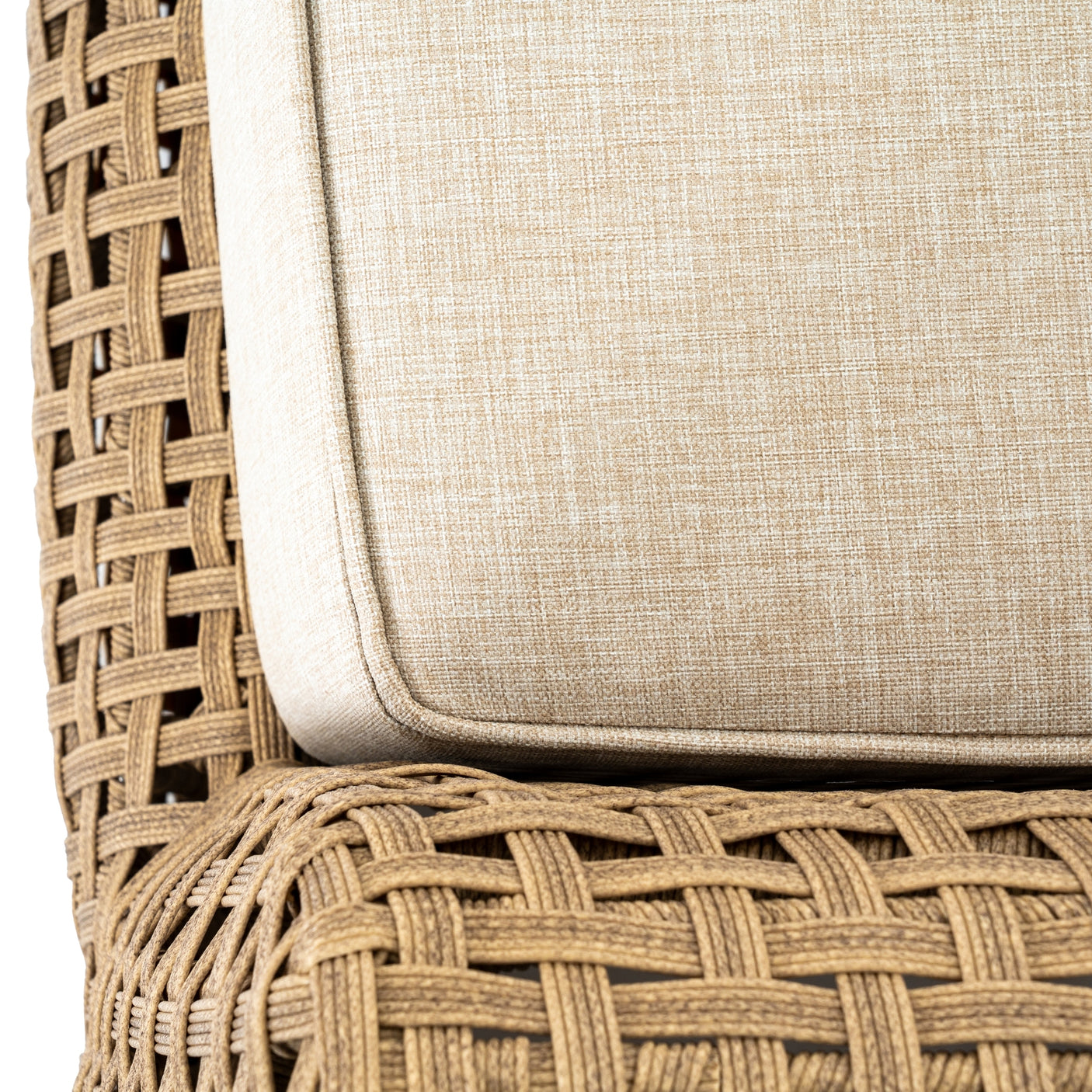 Close-up of a wicker chair with a beige cushion