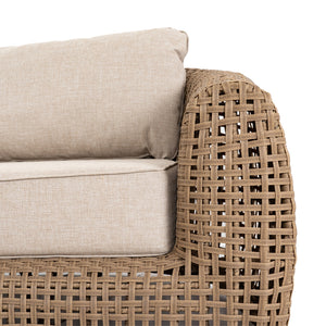 Wicker sofa with beige cushions on a white background
