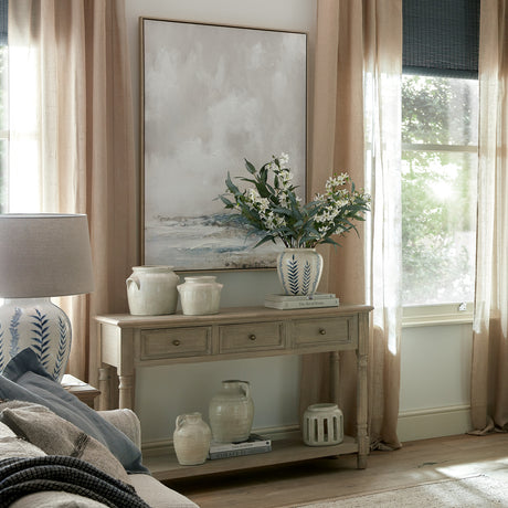 Living room with a wooden console table, decorative vases, and a painting on the wall.
