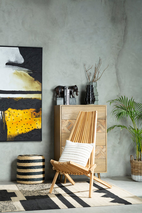 Marano wooden lounge chair with plant, and abstract art on a gray wall.