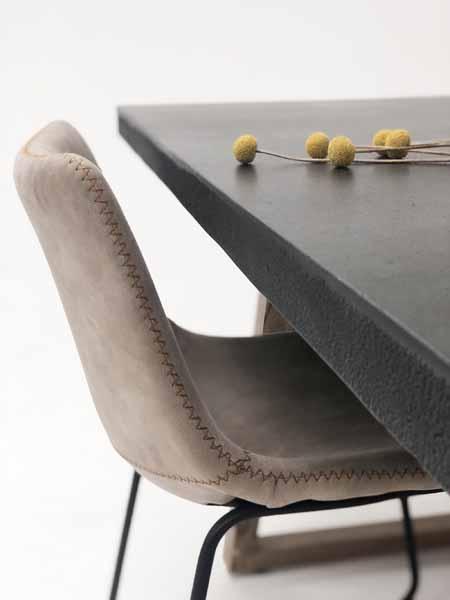 Gray chair with a textured backrest next to a gray table on a white background