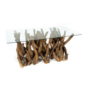 Glass-top dining table with natural teak root base on a white background