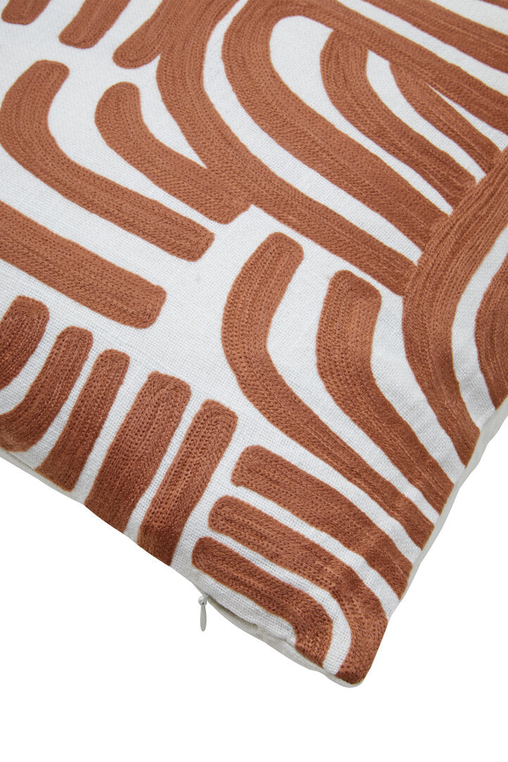 Corner of the square Elora Natural And Terracotta Cushion, showing the embroidery and zip