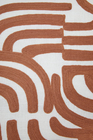 Close-up of the terracotta embroidered curves on the square Elora Natural And Terracotta Cushion