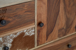Close-up of the cowhide drawer and rich wood grain on the Folklore sideboard