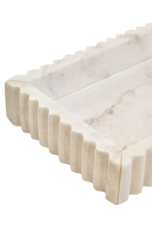 Close-up of a corner of the Vela White Marble Fluted Rectangular Tray, showing the fluting and grey veining in the base.