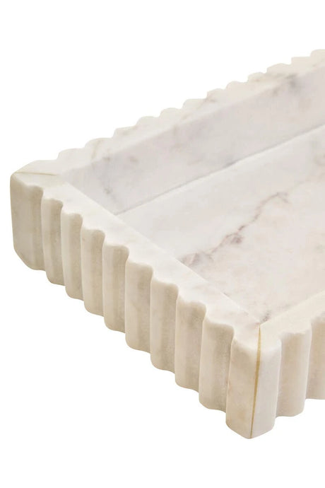 Close-up of a corner of the Vela White Marble Fluted Rectangular Tray, showing the fluting and grey veining in the base.