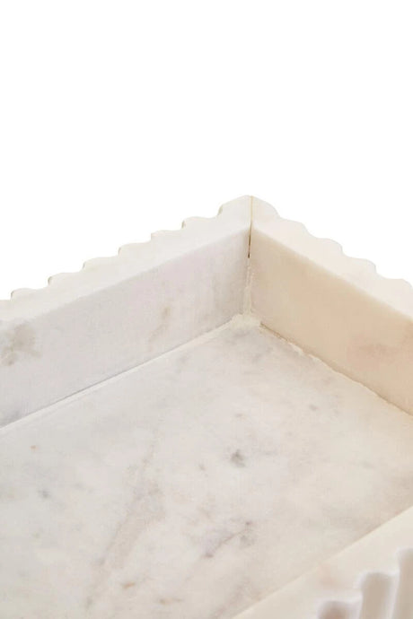 Close-up of the inside corner of the Vela marble tray, showing the smooth base and natural markings.