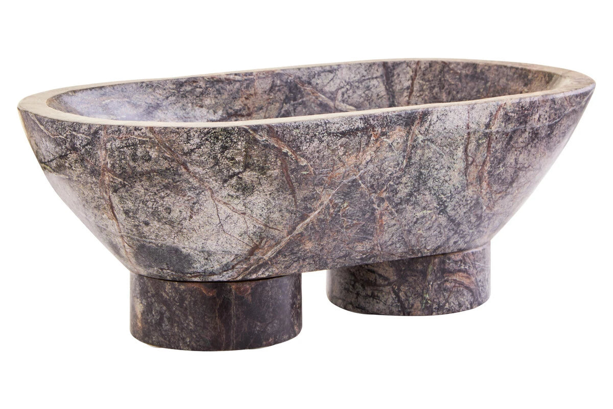 The Cairn Forest Green Marble Pedestal Bowl from a slight angle, showing the oval bowl raised on two round marble feet.