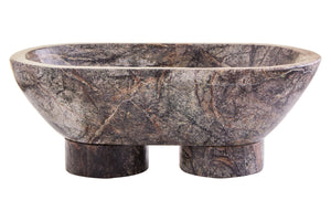Side view of the Cairn marble pedestal bowl, showing its two chunky cylindrical feet and rich green-grey veining.