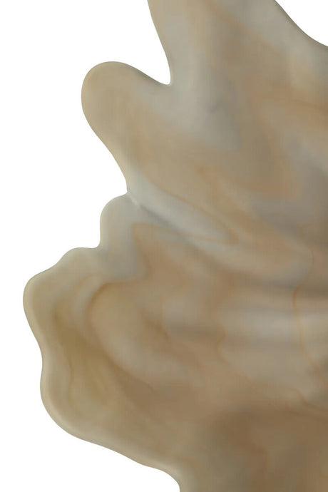 Close-up of a textured beige dish on a white background