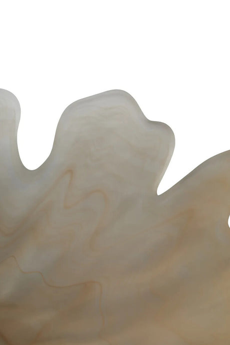 A close-up of a smooth, organic-shaped dish in warm off-white and beige tones against a plain white background.