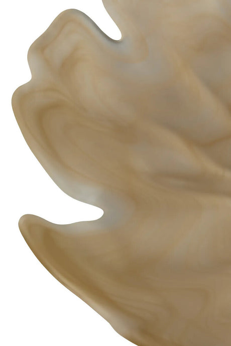 Close-up of a beige glass bowl with wavy edges on a white background