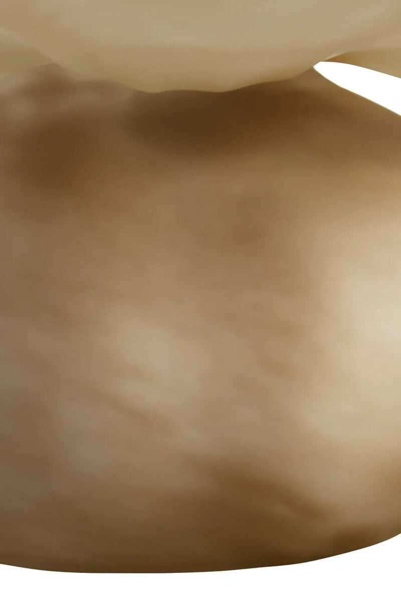 A close-up of a smooth, warm beige-brown surface with soft shading and a small light highlight at the top edge.