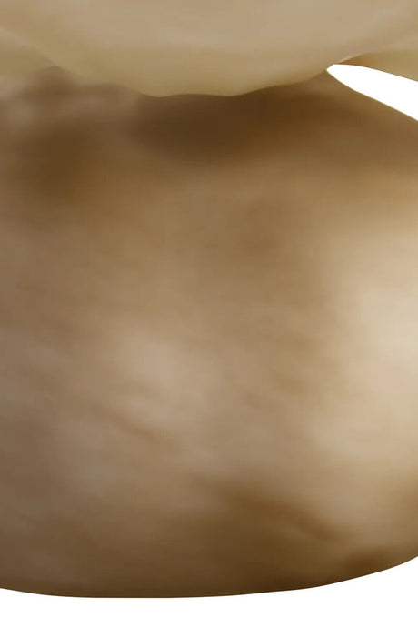 A close-up of a smooth, warm beige-brown surface with soft shading and a small light highlight at the top edge.