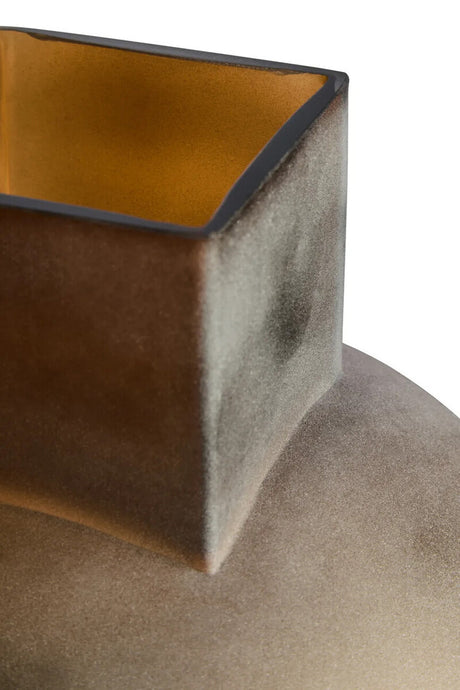 Close-up of a brown opaque glass vase on a white background