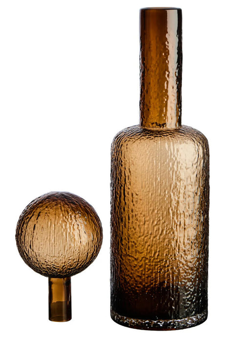 Brown glass bottle and spherical stopper on a white background