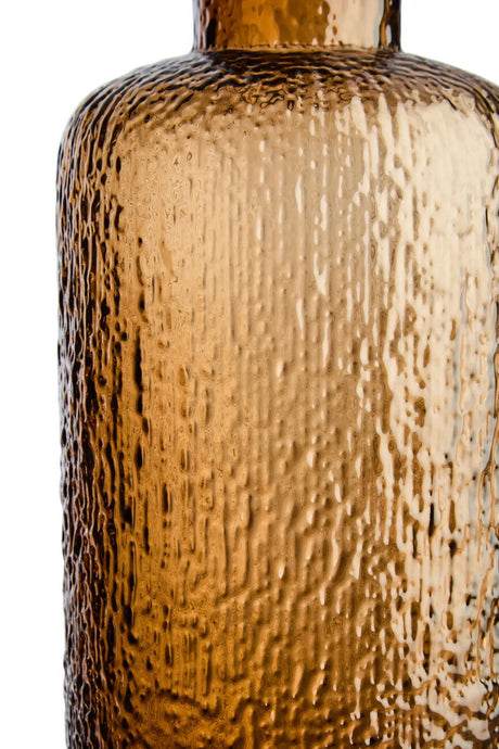 Close-up of a textured brown bottle on a white background