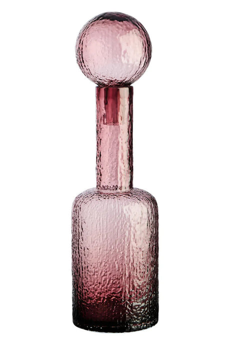 Pink glass bottle with a textured design on a white background