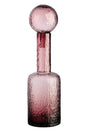 Pink glass bottle with a textured design on a white background