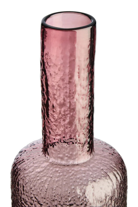 Pink glass vase with textured surface on a white background