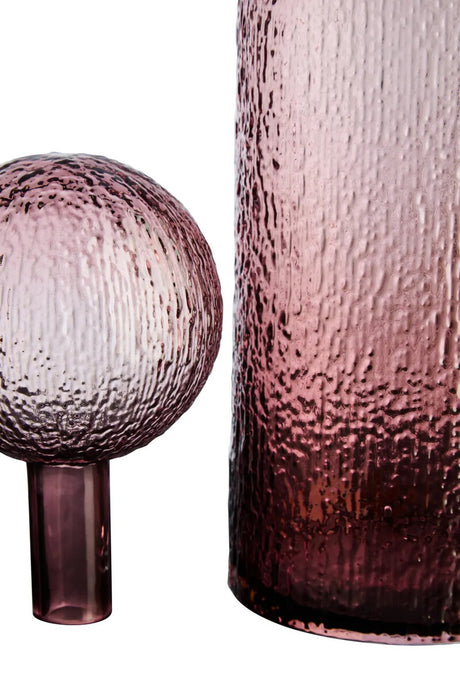 Two textured glass pieces, one spherical and one cylindrical, on a white background.