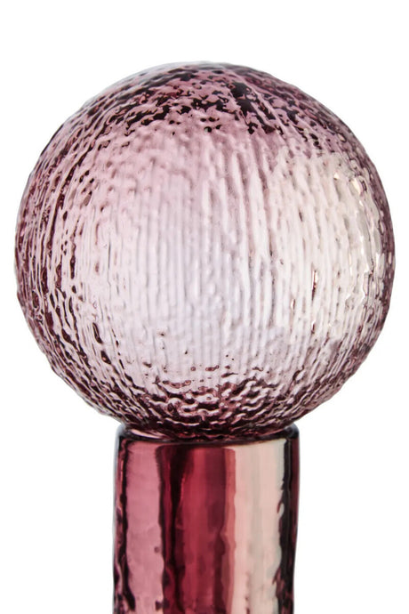 Decorative glass stopper on a white background