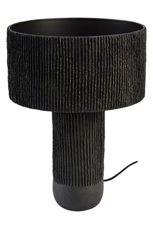 A black papier mache table lamp on a white background