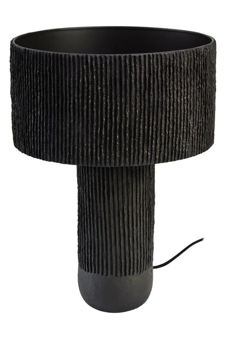 A black papier mache table lamp on a white background