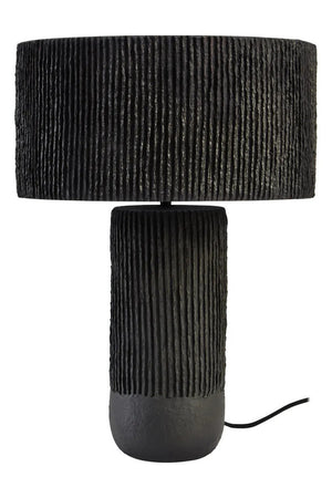 A black ribbed table lamp on a white background