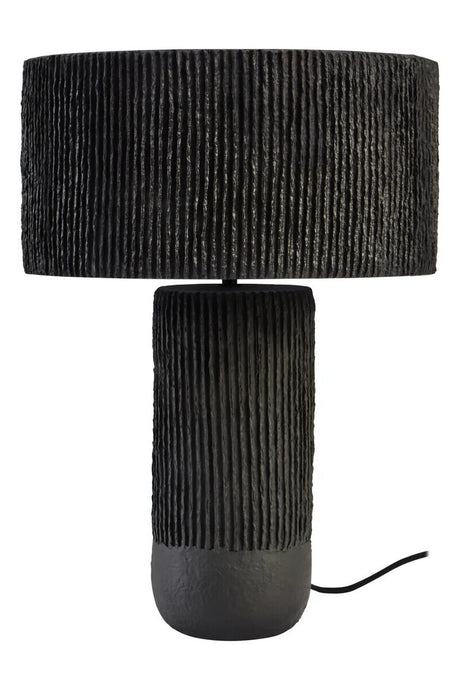 A black ribbed table lamp on a white background