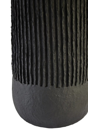 Base of a black ribbed table lamp on a white background
