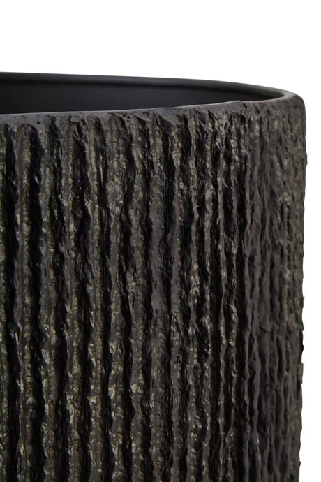 Close up of the ribbed detail of the Luma black table lamp on a white background