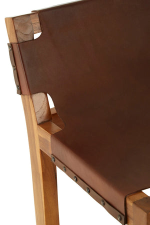 Close-up of the brown leather backrest of the Jakarta Bar Chair wrapped around the teak frame, with antique studs.