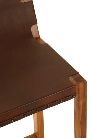 Close-up of the brown leather seat of the Jakarta Bar Chair, showing the studded edge and teak corner joint.