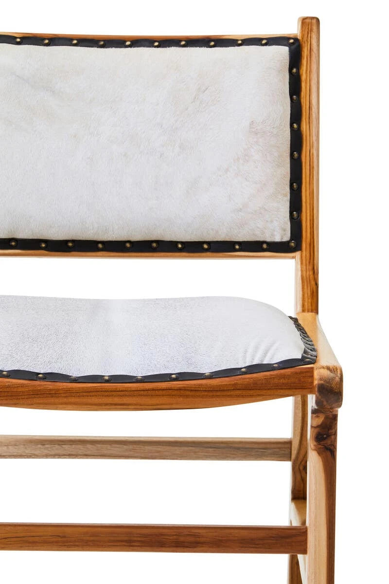 Close view of the Jakarta Dining Chair, showing the cream hair-on cowhide back and seat in the teak frame.
