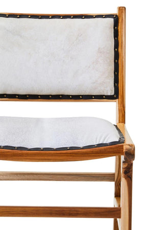 Close view of the Jakarta Dining Chair, showing the cream hair-on cowhide back and seat in the teak frame.