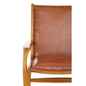 Close view of the tan leather seat and back of the Jakarta Chair with Stud Detail, with studs along the edge.