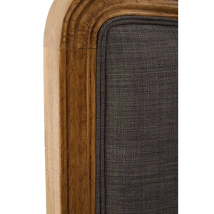 Close-up of the moulded oak frame edge against the grey linen-look upholstery on the Vienne bed.