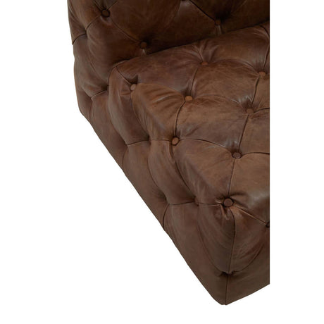 Close up of front corner of Durango brown leather chesterfield armchair on a white background
