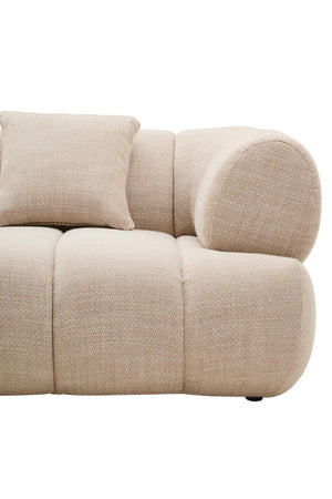 Beige sofa with rounded cushions on a white background