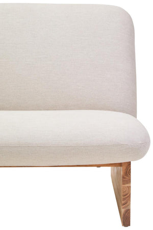 Cream linen armless sofa with wooden legs on a white background