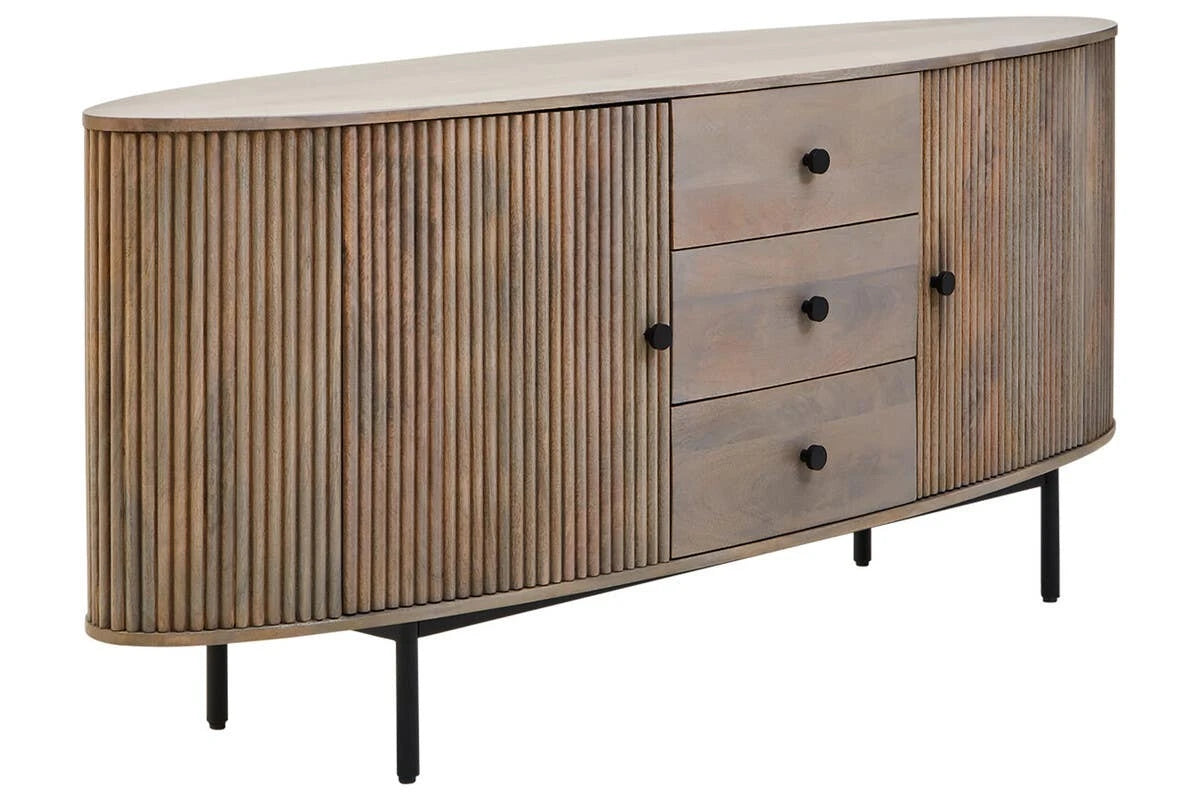 The Hawthorn Grey Oval Sideboard from a three-quarter angle, showing its rounded ends, reeded doors and three drawers with black knobs.