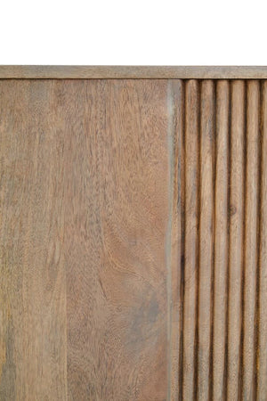 Close-up of the grey-washed mango wood grain beside the reeded end of the Hawthorn Grey Oval Sideboard.